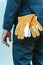 Close-Up of Mechanic Technician Hand and Leather Gloves While Standing in front of Maintenance Workshop, Technical Service Worker