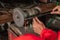 Close up of mechanical hands using a grinding machine to smooth the ends of the bolts