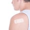 Close up of medical adhesive plaster on male shoulder isolated o