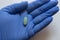 Close-up. Medical glove with Green oval tablets