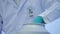 Close-up of a Medical research scientist takes out glass bottle with experimental solution liquid from a cryogenic