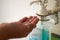 Close up of a medical worker in protective clothing washing her hands