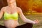 Close-up of meditating pregnant woman, free space