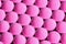 Close-up of melatonin tablets. photo in pink tones. dietary concept. dietary supplement topview