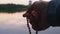 Close-up, Men Hand Holds Little Rosary, Evening Prayer on the River Bank