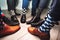 Close up of men legs wearing formal shoes and funny colorful socks. Seven friends feet in circle composition.