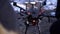 Close-up of men prepared quadcopter for flight. Clip. Two men admire latest version of quadcopter with powerful motors