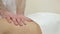 Close-up. Men\'s hands doing massage girl back