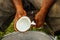 Close-up of men`s hands scraping coconuts in Lavena village, Ta