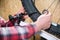 Close-up of men`s hands with a specialized wrench on a stand in the workshop tightening the spokes of the wheel