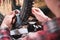 Close-up of men`s hands with a specialized wrench on a stand in the workshop tightening the spokes of the wheel