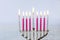 Close up of menorah with candles for Hanukkah on white background