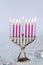 Close up of menorah with candles for Hanukkah on white background