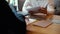 Close-up of mens hands are signing papers and handing them over to colleague