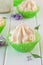 Close up of meringue cake near lilac flowers