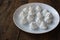 Close-up of meringue on a white plate. Marshmallows on wooden table background