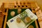 close up metal euro currency coin, banknotes of european union on wooden board game Philos Shut Box, concept gambling for money,