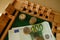 close up metal euro currency coin, banknotes of european union on wooden board game Philos Shut Box, concept gambling for money,