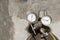 Close-up of a metal gas cylinder with a reducer and a pressure sensor in the background industrial workshop