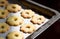 Close up of metallic baking tin with canestrelli biscuits