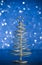 Close-up of metallic modern christmas tree on wood table