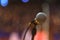 Close up of microphone over abstract blurred of attendee in seminar room or conference hall