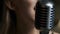 Close-up of Microphone and Talented Singer at Background. Shot on Red Epic 4k Uhd Camera.