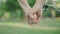 Close-up of mid-adult male and female hands taking each other outdoors. Unrecognizable loving Caucasian man and woman