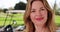 Close up of middle aged Caucasian woman on golf course smiling at camera