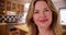 Close up of middle aged Caucasian woman inside home, smiling at camera