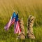 Close up of military boots near american flag with stars and stripes