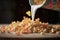 close-up of milk pouring onto cereal flakes