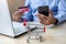 Close up mini cart, Asian businessman holding credit card using laptop and smart phone for online shopping while making orders.