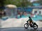 Close up Mini Figure Woman toys bicycling at Water Park White Horizontal Pool with negative or copy space for text area placement