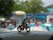 Close up Mini Figure Woman toys bicycling at Water Park White Horizontal Pool with negative or copy space for text area placement