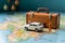 Close up Miniature businessman, suitcase, handbag, and white car amid a vibrant world map