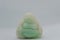 Close-up of a miniature jade carving of the `Laughing Buddha` or Budai