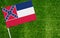 Close-up of Mississippi flag against closed up view of grass