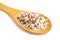 Close-up of mixed dry organic wild brown and white rice grain in a wooden spoon, isolated. Ingredient for cooking. Healthy food
