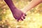 Close up on a mixed race couple holding hands