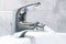 Close up of the mixer tap of a bidet with running water. The bidet was invented in France in the late 1700s