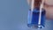 Close up mixing of medicine. Syringe squirting fluid into ampoule