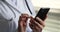 Close up mobile phone device in female doctor hands