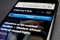 Close up of mobile phone screen with website of Frontex european border and coast guard agency selective focus on E in Frontex