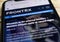 Close up of mobile phone screen with website of Frontex european border and coast guard agency selective focus on E in Frontex