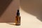 Close-up of mock-up of glass dropper bottle on abstract beige-brown background in rays of sunlight. Concept of natural