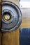 Close-up of a modern semi-circular door handle carved from aged wood