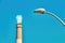 Close up on modern street lamp post and Reading power plant chimney
