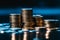 Close up: Money coins, stack, black background, with a blue filter