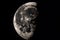 close-up of the moon, with its surface and craters visible during partial lunar eclipse